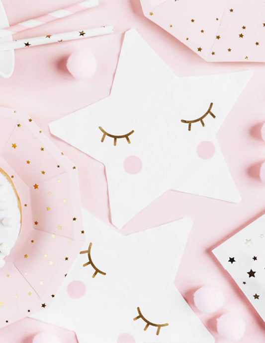 Détail du motif visage des serviettes en papier petite étoile blanche aux yeux dorés