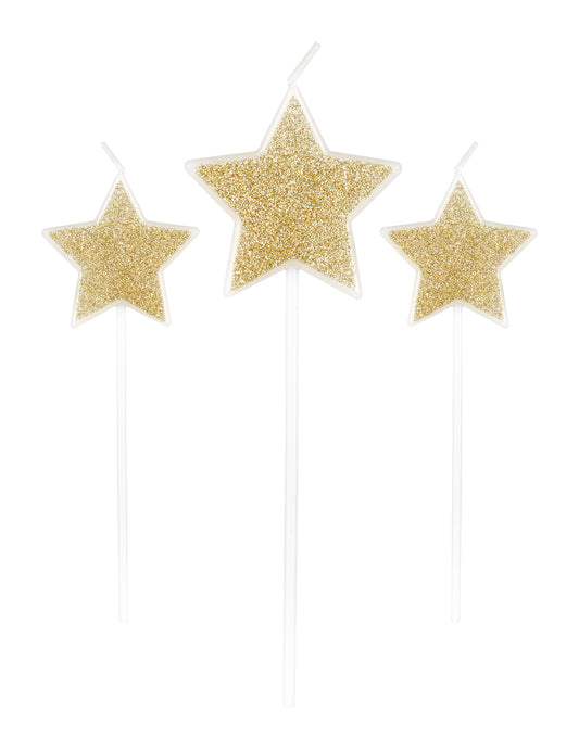 3 bougies sur pic étoiles pour fête paillettes champagne