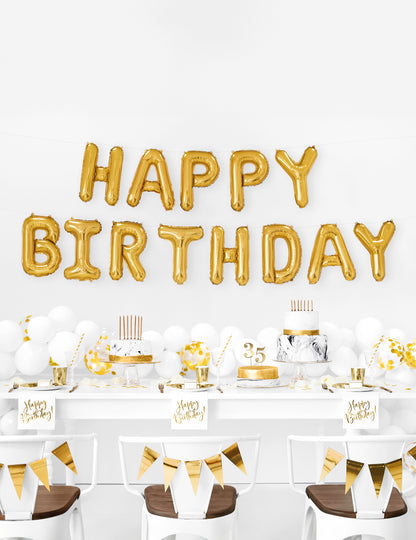 Mise en scène décorative des ballons aluminium lettres Happy Birthday pour anniversaire doré en guirlande