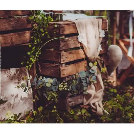 Mise en situation sur des caisses en bois de la couronne en métal d'eucalyptus et fleurs blanches cercle zlatna