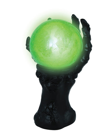 Crna kosturova ruka sa svjetlećom kristalnom kuglom