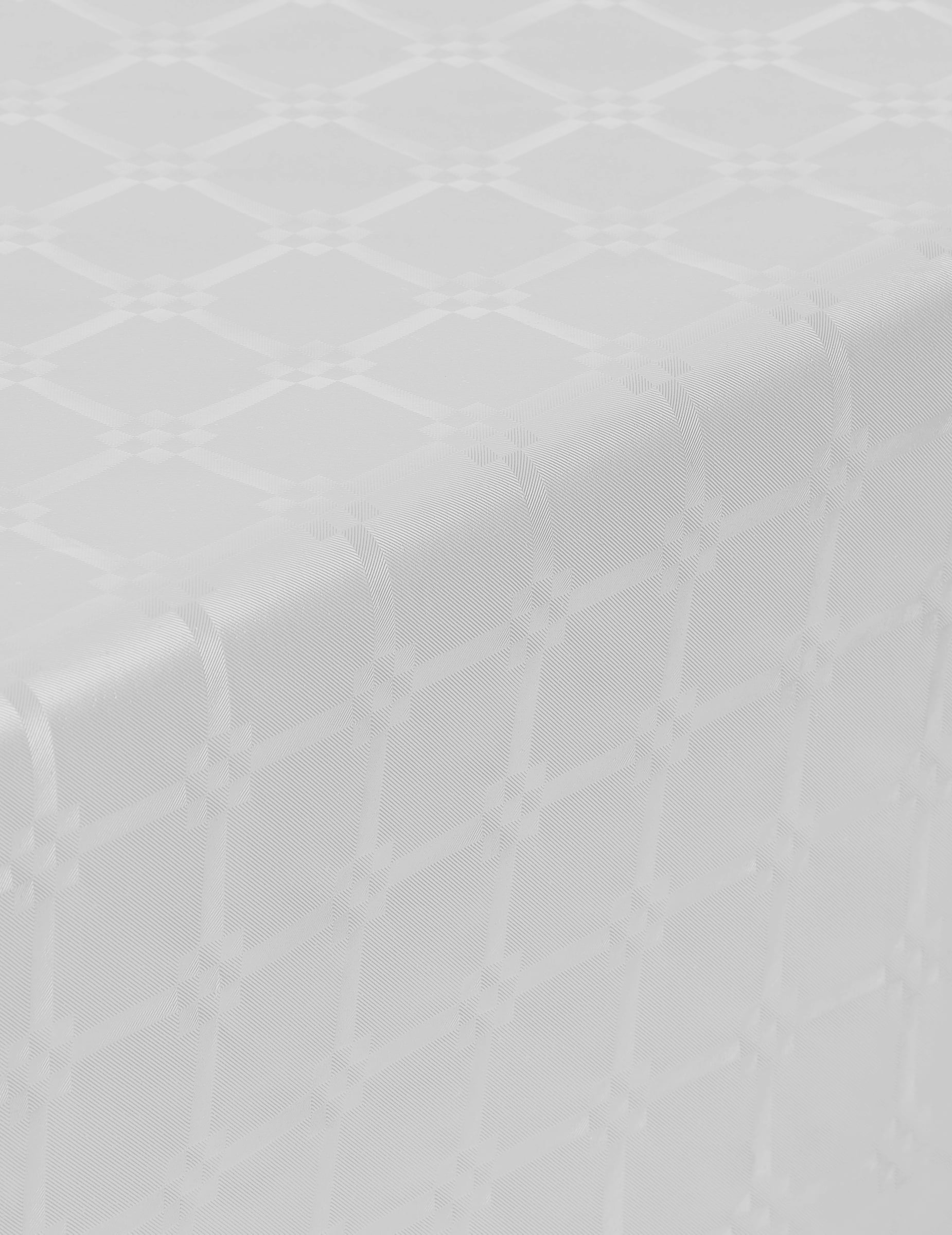 Détail du motif damassé de la nappe en rouleau papier damassé blanche
