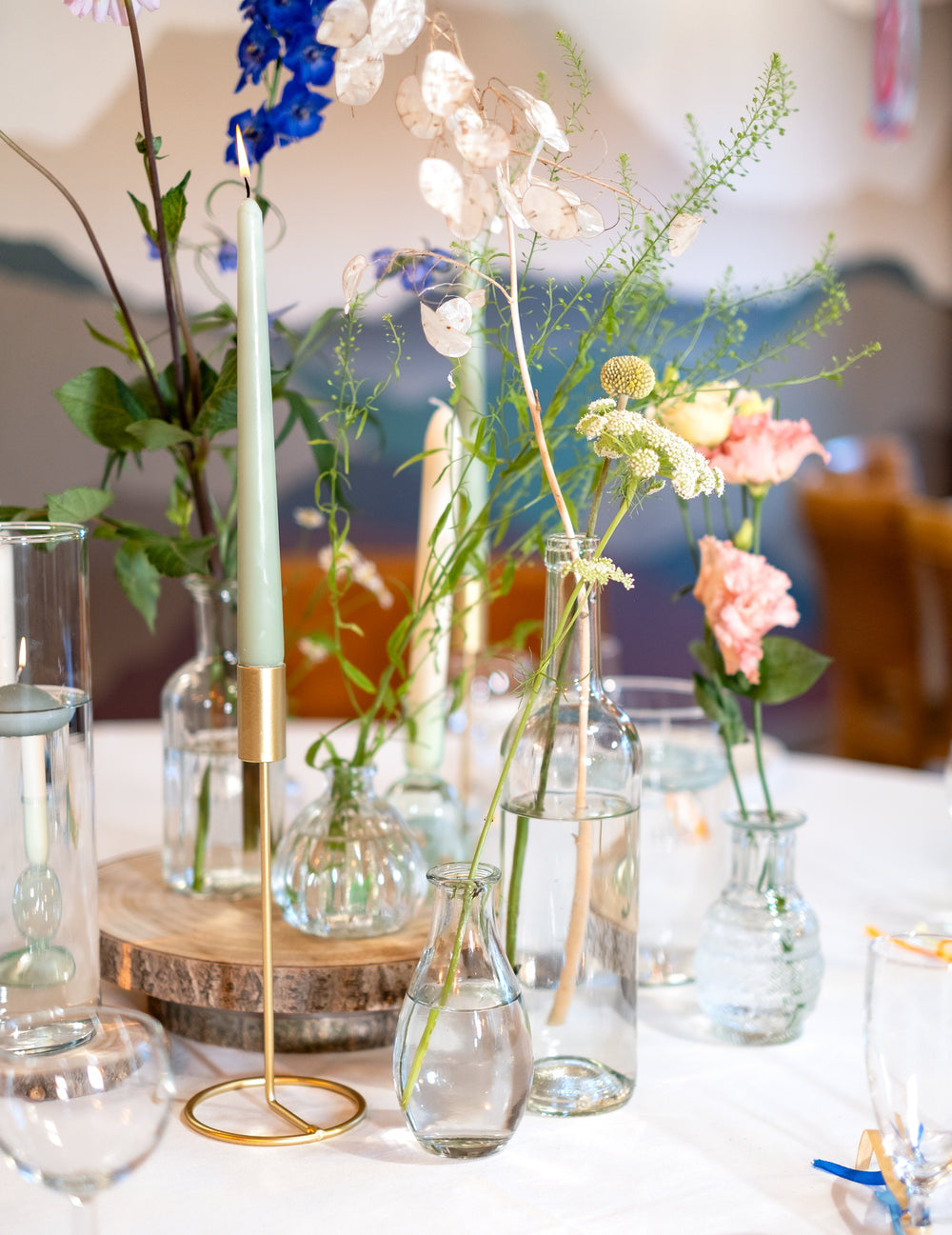 Composition florale avec bougies du vase soliflore en verre pour décoration de table